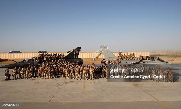 French pilots pose for a group photo at Kandahar air base in front of Rafale and Mirage combat aircraft. France redeployed six fighter planes from...