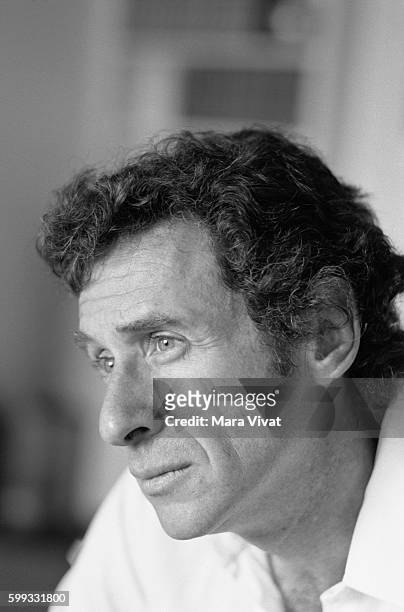 Motion picture director Arthur Penn, director of Bonnie and Clyde, relaxes on a sofa.