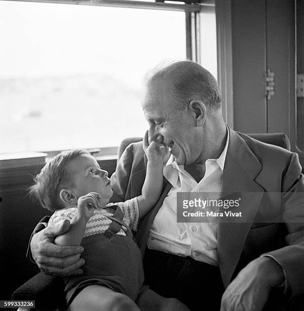 Little boy plays with the nose of comedian Jimmy Durante, also known as Schnozzola.