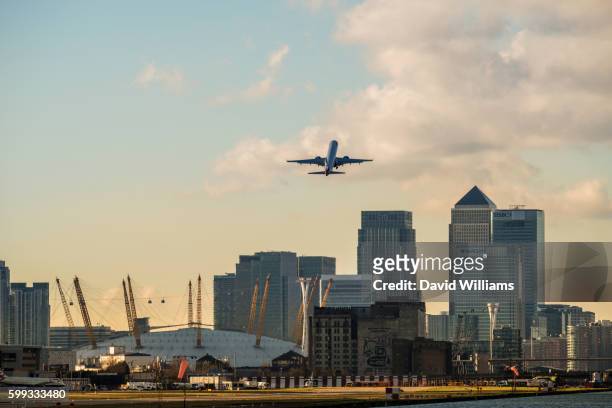 british airways jet plane takes off from london city airport in east london - ba stock pictures, royalty-free photos & images
