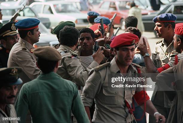 Soldiers apprehend suspects after the assassination of President Anwar Sadat at a military parade.