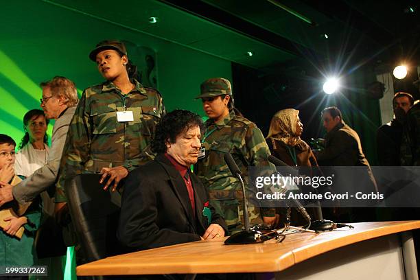 Libyan leader Moammar Gaddafi, surrounded by his female bodyguards, attends a meeting with female personalities at the Pavillon Gabriel.