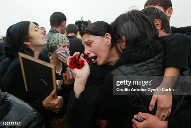 Families cry for victims of the Beslan school siege as they bury their loved ones at Vladikavkaz cemetery. 318 civilians, including 186 children,...