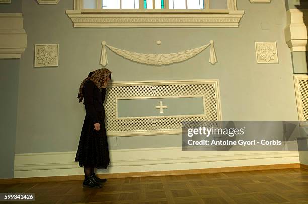 Young woman is praying during a mass held at the Theology Academy.The Russian Orthodox Church is the main and semi-official religion of the Russian...