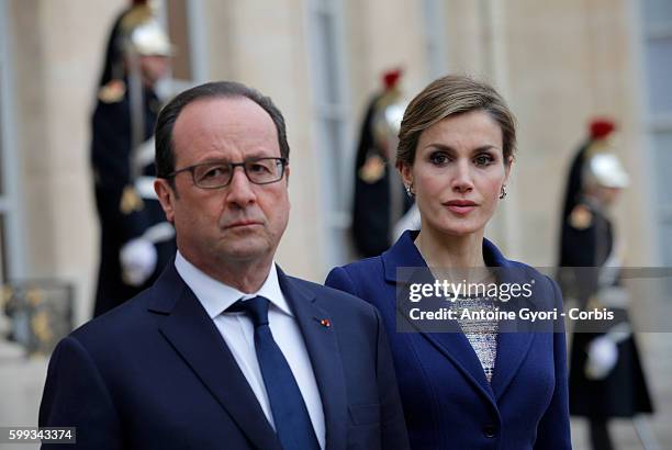 King Felipe of Spain, flanked by Queen Letizia, French President Francois Hollande are delivering a speech at the Elysée palace following the crash...