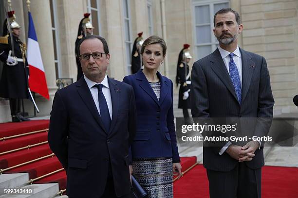 King Felipe of Spain, flanked by Queen Letizia, French President Francois Hollande are delivering a speech at the Elysée palace following the crash...