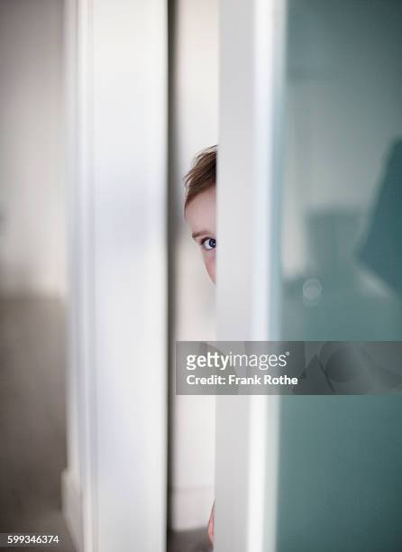 baby girl (2-3 years) peeking through doorway - kid peeking stock pictures, royalty-free photos & images