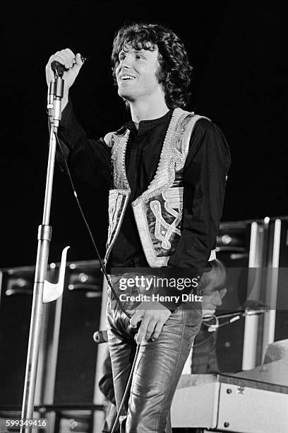 Jim Morrison of The Doors stands on stage during a 1968 concert at the Hollywood Bowl. Keyboardist Ran Mansarek is in the background.
