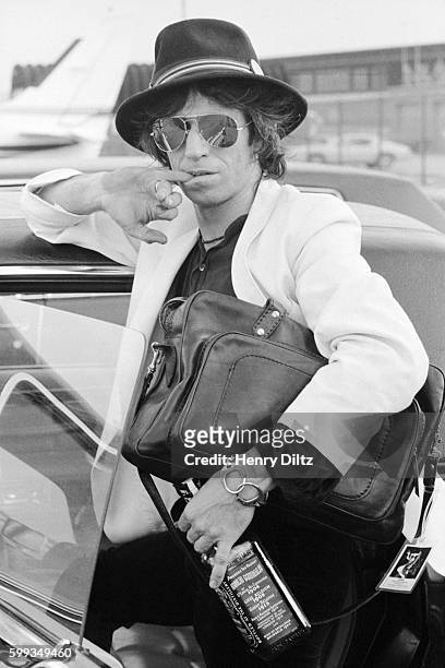 Keith Richards stands at an airport during his 1979 New Barbarians tour.