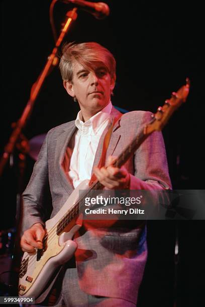 Singer and songwriter Nick Lowe performs on guitar in concert. Known more for producing and writing for rock bands such as the Damned, Elvis...
