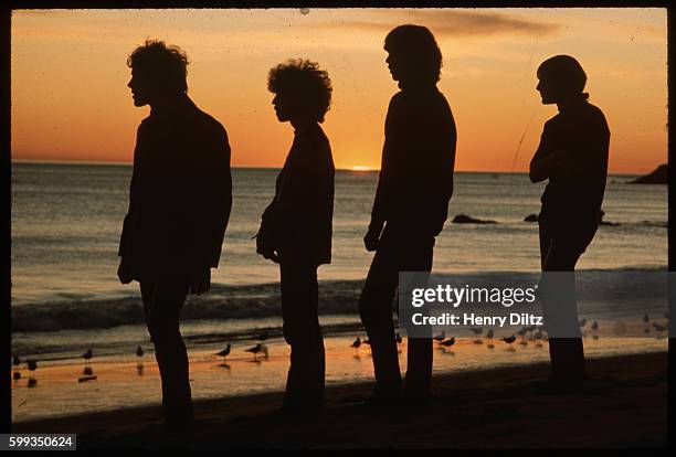 An album cover portrait of rock band Things to Come during a beachside sunset in the early 1970s.