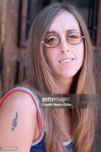 Portrait of 1960's hippie generation musician Judee Sill with a treble clef tattoo.