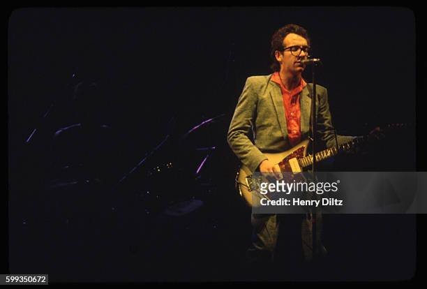 Singer and songwriter Elvis Costello performs with the Attractions in concert. Popular for his late 1970s New Wave style of folk acoustic rock....