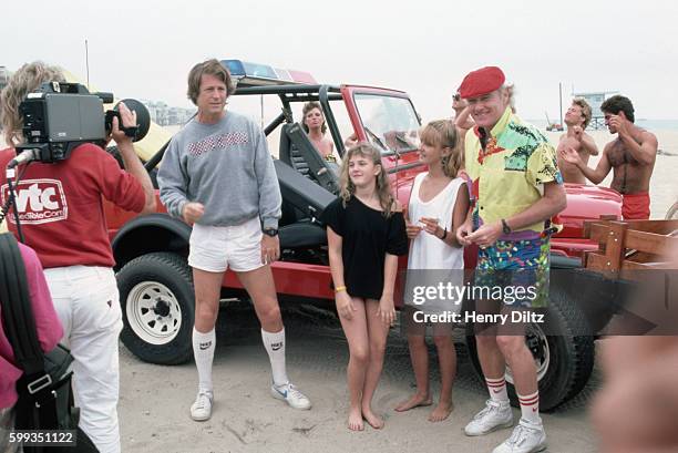 Brian Wilson and Mike Love of the Beach Boys stand with a young Drew Barrymore and her friend.