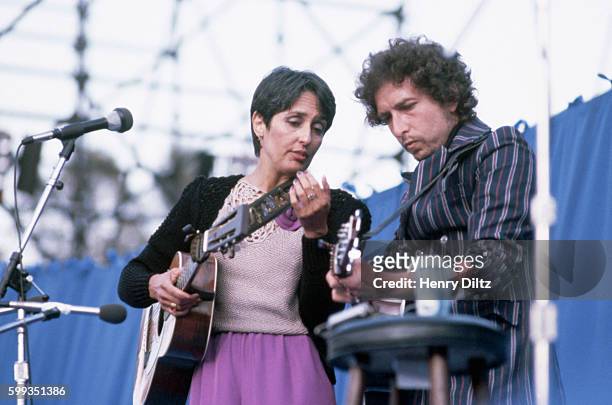 Folk singer Joan Baez and Bob Dylan perform together in concert.