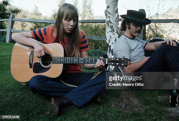 Folk-rock singer David Crosby listens to Joni Mitchell playing a song, February 1968.