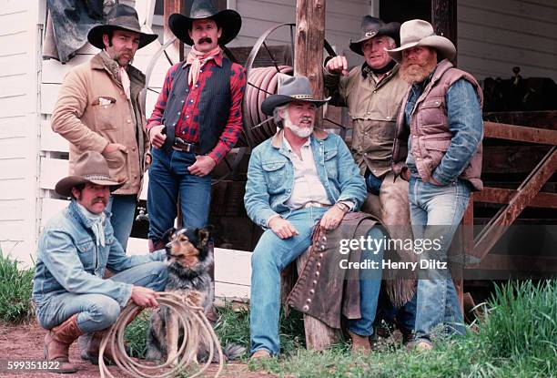 Singer Kenny Rogers and some actors dress as cowboys for a photo session. Rogers is best known for the songs "Lucille" and "The Gambler" and...