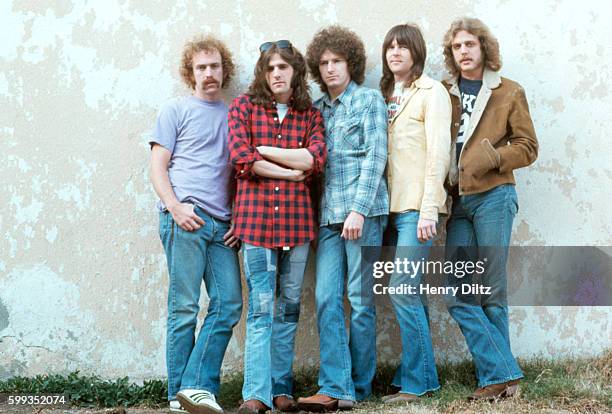 The members of The Eagles stand against a wall. The Eagles were the most popular band of the seventies and their reunion tour in the nineties was...