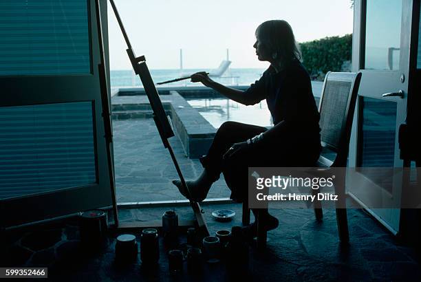 Joni Mitchell paints in a waterfront studio. She painted most of her record covers and considers her painting equal to her music. Mitchell remains...