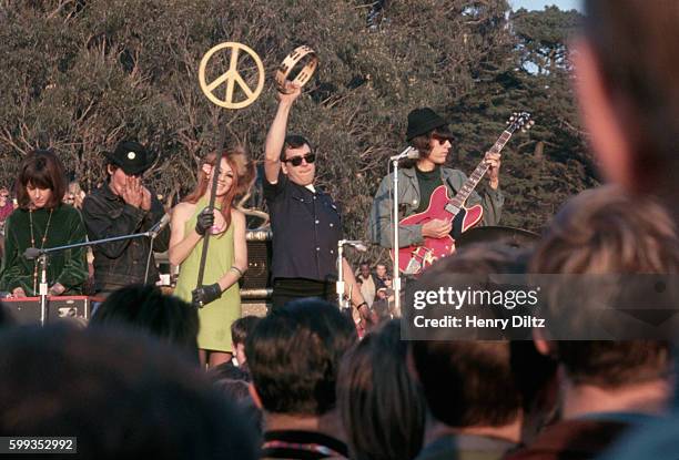 Rock band and a go-go dancer perform on stage at the Human Be-In. Golden Gate Park, San Francisco, California, USA.