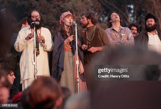 Beat poet, Allen Ginsberg addresses the Human Be-In with hippie singers backing him up. Golden Gate Park, San Francisco, California, USA.