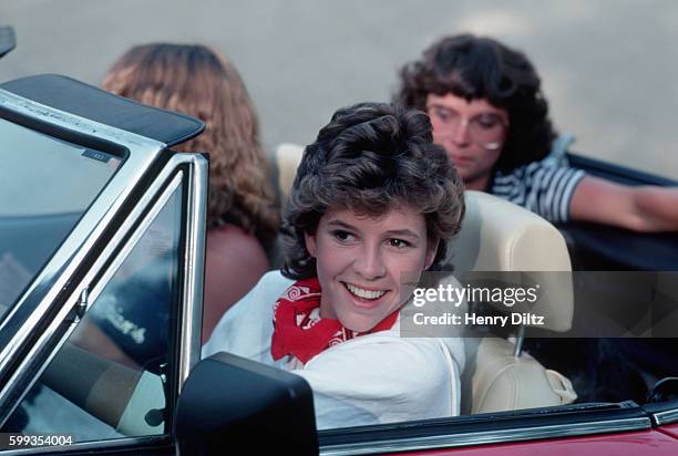 Kristy McNichol drives a convertible with two actresses acting as passengers on the set of White Dog.