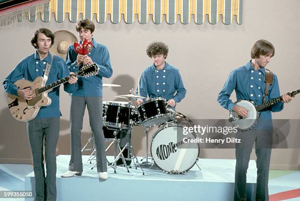 The Monkees perform on their television show wearing matching blue shirts.