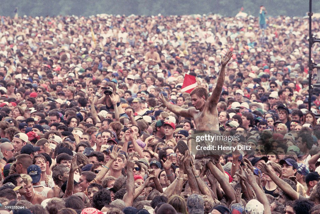 Concertgoers Passing Man Through Crowd