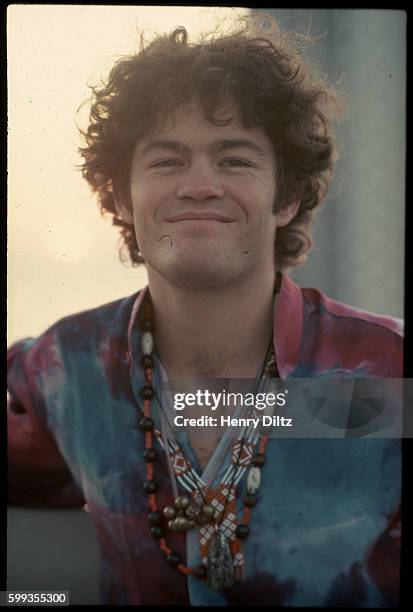 Micky Dolenz of The Monkees wears a tie dyed shirt on a hotel roof at dawn.