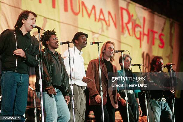 The members of the "Human Rights Now!" world tour sing together in a row at the Los Angeles show. From left, Peter Gabriel, Tracy Chapman, Youssou...