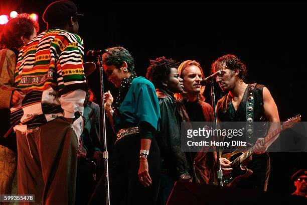 Musicians Bruce Springsteen, Sting, Tracy Chapman, Joan Baez, Peter Gabriel, and Youssou N'Dour perform together at the Los Angeles Coliseum during...