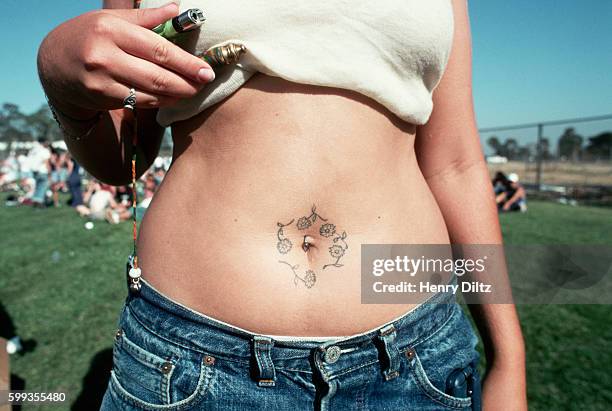 woman with tattoo and navel ring - belly ring foto e immagini stock