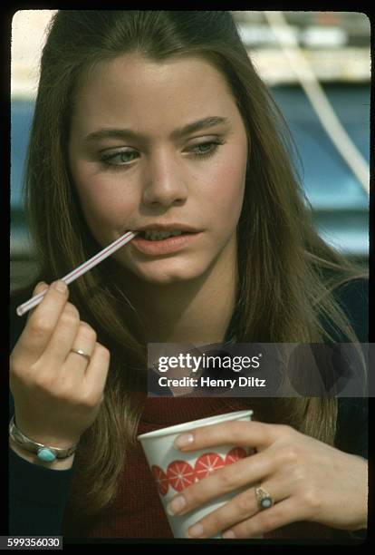 Portrait of Susan Dey, actress on the television show The Partridge Family, biting on a straw.