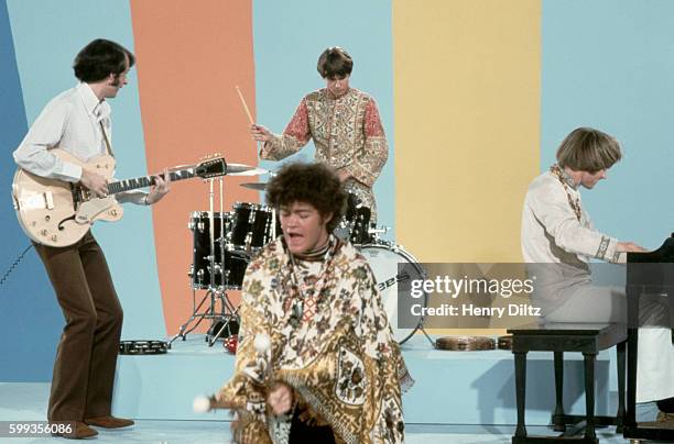 The Monkees play instruments and goof off on their television show.