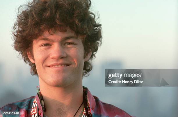 Micky Dolenz of The Monkees wears a tie dyed shirt on a hotel roof at dawn.