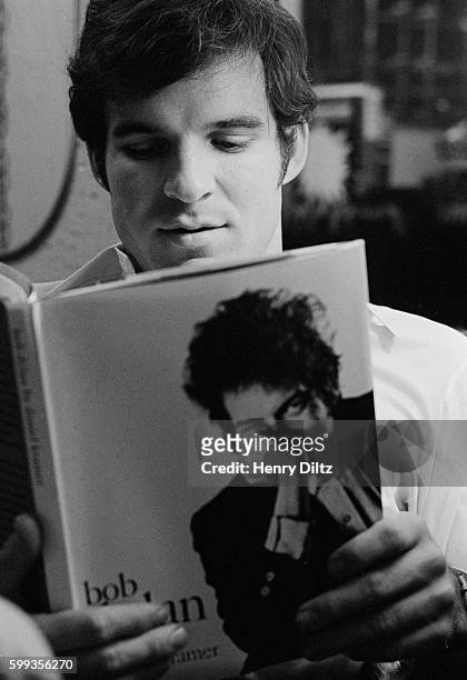 Steve Martin Reading Book About Bob Dylan