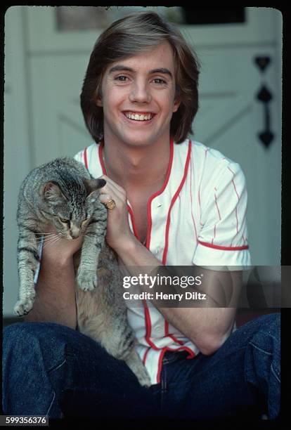 Shaun Cassidy holds a tabby cat at his mother Shirley Jone's house. Published in Bravo Magazine.