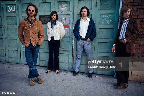 Rock band the Doors are : guitarist Robbie Krieger, drummer John Densmore, singer Jim Morrison, and keyboardist Ray Manzarek. The writing between...