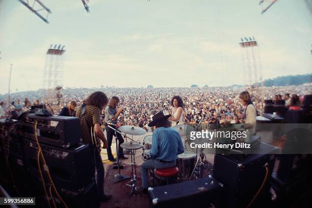 Jefferson Airplane on stage, playing before a massive audience of the Woodstock Music and Art Fair. | Location: Near Bethel, New York, USA.