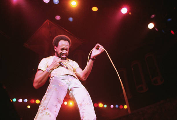 Maurice White sings in concert with the 1970s funk band, Earth, Wind and Fire.