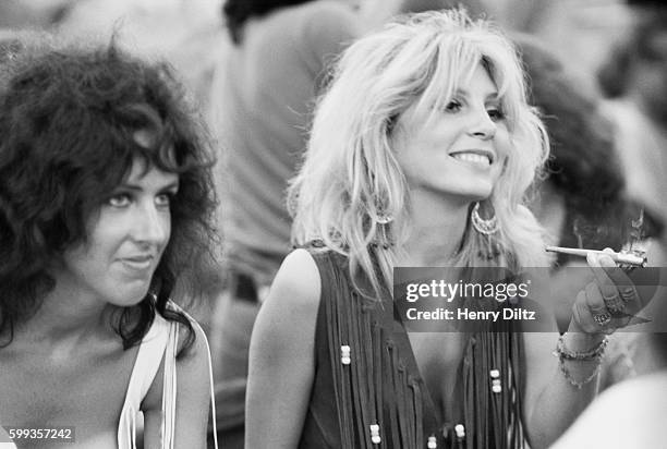 Sally Mann , holding a joint, sits next to Grace Slick at the free Woodstock Music and Art Fair. | Location: Near Bethel, New York, USA.