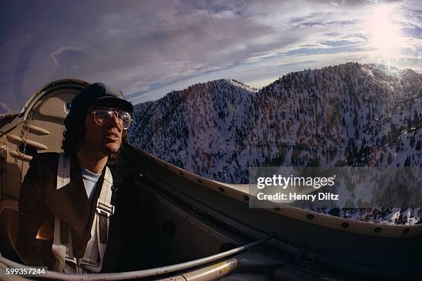 Singer and songwriter Jimmy Webb enjoys the view from the cockpit of a plane. This photograph was used for the cover of his 1974 album, Land's End.