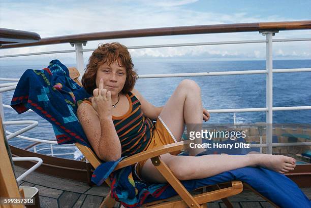 Danny Bonaduce, who plays the character Danny Partridge on The Partridge Family television series, flips the bird while relaxing aboard a cruise...