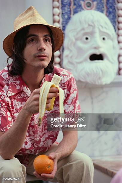 Folk musician Jackson Browne sits with a banana and orange outside the J. Paul Getty Museum in Los Angeles.