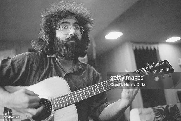 Grateful Dead frontman Jerry Garcia plays an acoustic guitar during a rehearsal jam session at the home of Grace Slick and Paul Kantner in Bolinas,...