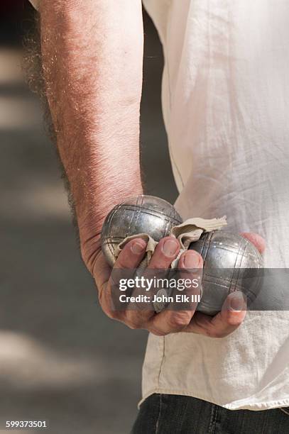 man holding petanque balls - nimes stock pictures, royalty-free photos & images