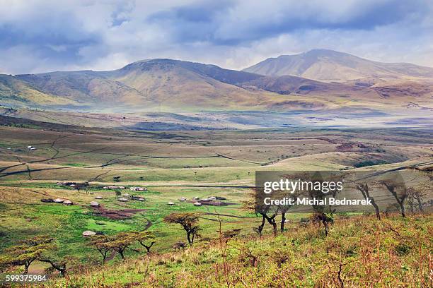 landscape in tanzania, africa with maasai houses in the valley - bednarek stock pictures, royalty-free photos & images