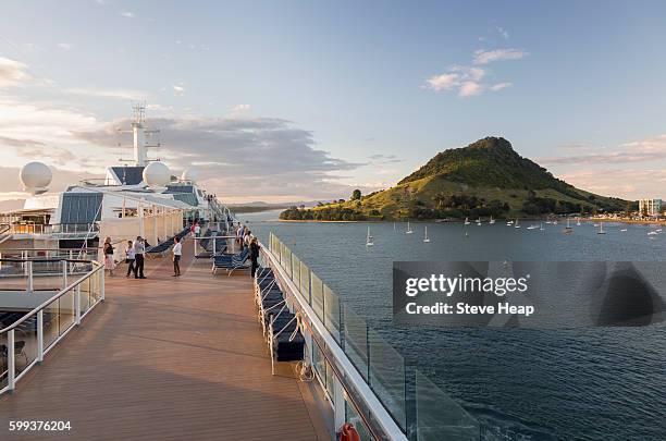 cruise ship in the bay at tauranga, new zealand at dusk - tauranga stock pictures, royalty-free photos & images