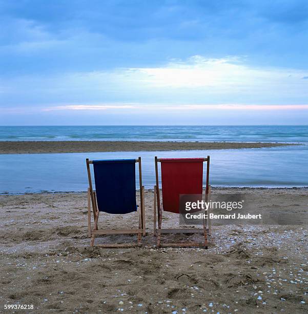 two deckchairs on the beach at sunset - bernard jaubert stock pictures, royalty-free photos & images