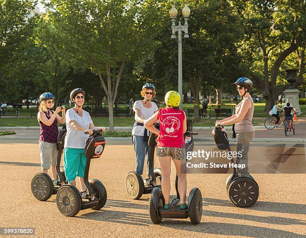 group of tourists on segway vehicles on pennsylvania avenue, washington dc, usa - segway stockfoto's en -beelden